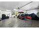 The garage features epoxy floors, a golf cart, and plenty of room for storage at 1430 Challenger Ave, Davenport, FL 33897