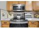 Well-equipped kitchen featuring granite countertops, stainless steel appliances, and wood cabinetry at 1430 Challenger Ave, Davenport, FL 33897