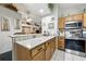 Open kitchen area with granite countertops, stainless appliances, and seamless connection to the dining room at 1430 Challenger Ave, Davenport, FL 33897