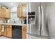 Modern kitchen with stainless steel appliances, granite counters, tile backsplash, and lots of counter space at 1430 Challenger Ave, Davenport, FL 33897