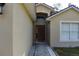 Inviting front entrance with an arched window above the dark wooden door at 1436 Swan Ct, Kissimmee, FL 34759