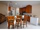 Bright kitchen featuring a breakfast bar, granite countertops, and light wood cabinetry at 1436 Swan Ct, Kissimmee, FL 34759