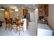 Open kitchen with a breakfast bar and wooden stools, and granite countertops at 1436 Swan Ct, Kissimmee, FL 34759