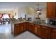 Modern kitchen featuring stone countertops, wood cabinets, and stainless steel appliances at 1436 Swan Ct, Kissimmee, FL 34759