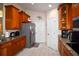 Well-lit kitchen featuring granite countertops, stainless steel refrigerator, and light wood cabinetry at 1436 Swan Ct, Kissimmee, FL 34759