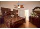 Spacious main bedroom with an ensuite bathroom, a ceiling fan, and a large wood-framed bed at 1436 Swan Ct, Kissimmee, FL 34759