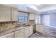 Bright kitchen featuring updated countertops, backsplash, cabinetry, and stainless steel appliances at 2005 Dalton Ave, Deltona, FL 32725