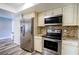 Updated kitchen with stainless steel refrigerator, microwave, and oven at 2005 Dalton Ave, Deltona, FL 32725