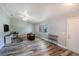 Cozy living room featuring stylish gray flooring, modern furnishings, and large window at 2005 Dalton Ave, Deltona, FL 32725