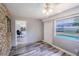 Inviting room with backyard pool views, modern ceiling fan, and stylish gray wood flooring at 2005 Dalton Ave, Deltona, FL 32725