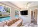 Bright living room features pool views, comfy sofa, and modern TV setup at 2005 Dalton Ave, Deltona, FL 32725