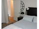 Bright bedroom featuring a large decorative clock and classic black headboard at 2480 Tahoe Cir # 2480, Winter Park, FL 32792