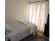 Minimalist bedroom design featuring a bed and curtains covering the window at 2480 Tahoe Cir # 2480, Winter Park, FL 32792