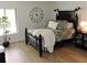 Cozy bedroom showcasing a decorative clock, large bed, and natural light at 2480 Tahoe Cir # 2480, Winter Park, FL 32792