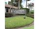 Cedarwood Village Condominiums entrance sign amid manicured bushes, welcoming residents and guests at 2480 Tahoe Cir # 2480, Winter Park, FL 32792