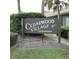 Cedarwood Village Condominiums entrance sign amid manicured bushes, welcoming residents and guests at 2480 Tahoe Cir # 2480, Winter Park, FL 32792