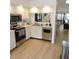 Modern kitchen with stainless steel appliances and a passthrough window to dining and living area at 2480 Tahoe Cir # 2480, Winter Park, FL 32792