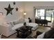 Cozy living room featuring a comfortable sofa and access to an outdoor patio at 2480 Tahoe Cir # 2480, Winter Park, FL 32792