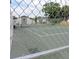 View of a fenced-in tennis court ready for play in a well-maintained community at 2480 Tahoe Cir # 2480, Winter Park, FL 32792