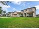 Charming home with a well-manicured lawn, a two-car garage, and lush palm trees at 2507 Water Valley Dr, St Cloud, FL 34771