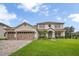 Charming two-story home featuring a three-car garage and lush landscaping at 2507 Water Valley Dr, St Cloud, FL 34771