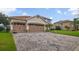 Lovely two-story home featuring a three-car garage and brick paver driveway at 2507 Water Valley Dr, St Cloud, FL 34771