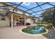 Inviting screened-in pool area features a beautiful pool with waterfall feature and plenty of lounging space at 2507 Water Valley Dr, St Cloud, FL 34771