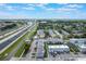 Expansive aerial view of a property near a bustling highway, surrounded by lush greenery and well-maintained buildings at 2791 L B Mcleod Rd # C, Orlando, FL 32805