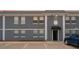 Modern apartment building with gray exterior, white trim and neatly marked parking spaces at 2791 L B Mcleod Rd # C, Orlando, FL 32805