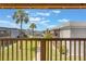Community views from balcony with wooden railing, featuring lawn and palm trees at 2791 L B Mcleod Rd # C, Orlando, FL 32805