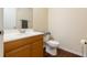Powder room featuring a wooden vanity, sink, toilet, and dark wood-look floors at 2791 L B Mcleod Rd # C, Orlando, FL 32805