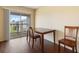 Bright dining area with wood-look flooring and sliding glass doors to a balcony with a neighborhood view at 2791 L B Mcleod Rd # C, Orlando, FL 32805