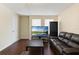 Cozy living room with a leather sofa, a flat-screen TV, and natural light streaming through the windows at 2791 L B Mcleod Rd # C, Orlando, FL 32805