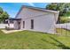 Spacious backyard showcasing a concrete patio, green lawn, and white fencing at 280 Bay St, Apopka, FL 32712