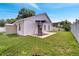 The backyard has a concrete patio with an awning, a lawn, and a white fence at 280 Bay St, Apopka, FL 32712
