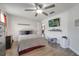 Bright bedroom features a ceiling fan, a TV, and access to an ensuite at 280 Bay St, Apopka, FL 32712