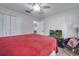Cozy bedroom with a ceiling fan, closet, and view to the hallway at 280 Bay St, Apopka, FL 32712