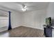 Well-lit bedroom with wood-look floors, paneling, and a window at 280 Bay St, Apopka, FL 32712
