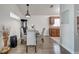 Dining area features modern lighting, views to the kitchen, and wood flooring throughout at 280 Bay St, Apopka, FL 32712