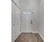 Bright foyer with wood-look floors, closet, and front door at 280 Bay St, Apopka, FL 32712