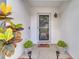 A welcoming front door with potted plants and a 'Home Sweet Home' doormat at 280 Bay St, Apopka, FL 32712