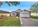 Charming single-story home with a well-manicured lawn and colorful landscaping at 280 Bay St, Apopka, FL 32712