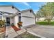 Close-up of front entryway with colorful plants, mulched beds and a two car garage at 280 Bay St, Apopka, FL 32712