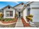 Close-up of front entryway with colorful plants, mulched beds and a walkway at 280 Bay St, Apopka, FL 32712