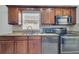 Kitchen featuring tile backsplash, stainless appliances, and wood cabinets providing a stylish touch at 280 Bay St, Apopka, FL 32712