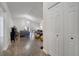 Open-concept living room with lots of light, wood-look floors, and vaulted ceiling at 280 Bay St, Apopka, FL 32712