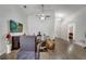 Well-lit living room with modern decor, wood floors, and entertainment center offers a cozy retreat at 280 Bay St, Apopka, FL 32712