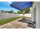 Concrete patio offers an awning and a table with chairs and an umbrella at 280 Bay St, Apopka, FL 32712