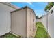 The backyard has a utility shed near a white fence and trees at 280 Bay St, Apopka, FL 32712