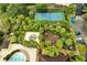 This aerial view shows the community playground, splash pad, pool, and tennis court at 2820 Oakwater Dr # 2820, Kissimmee, FL 34747